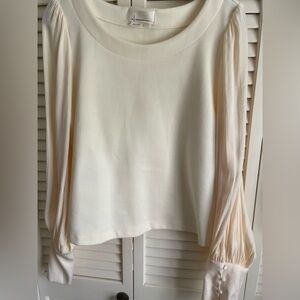 Anthropologie cream/ivory cropped top with button detail on the cuffs.